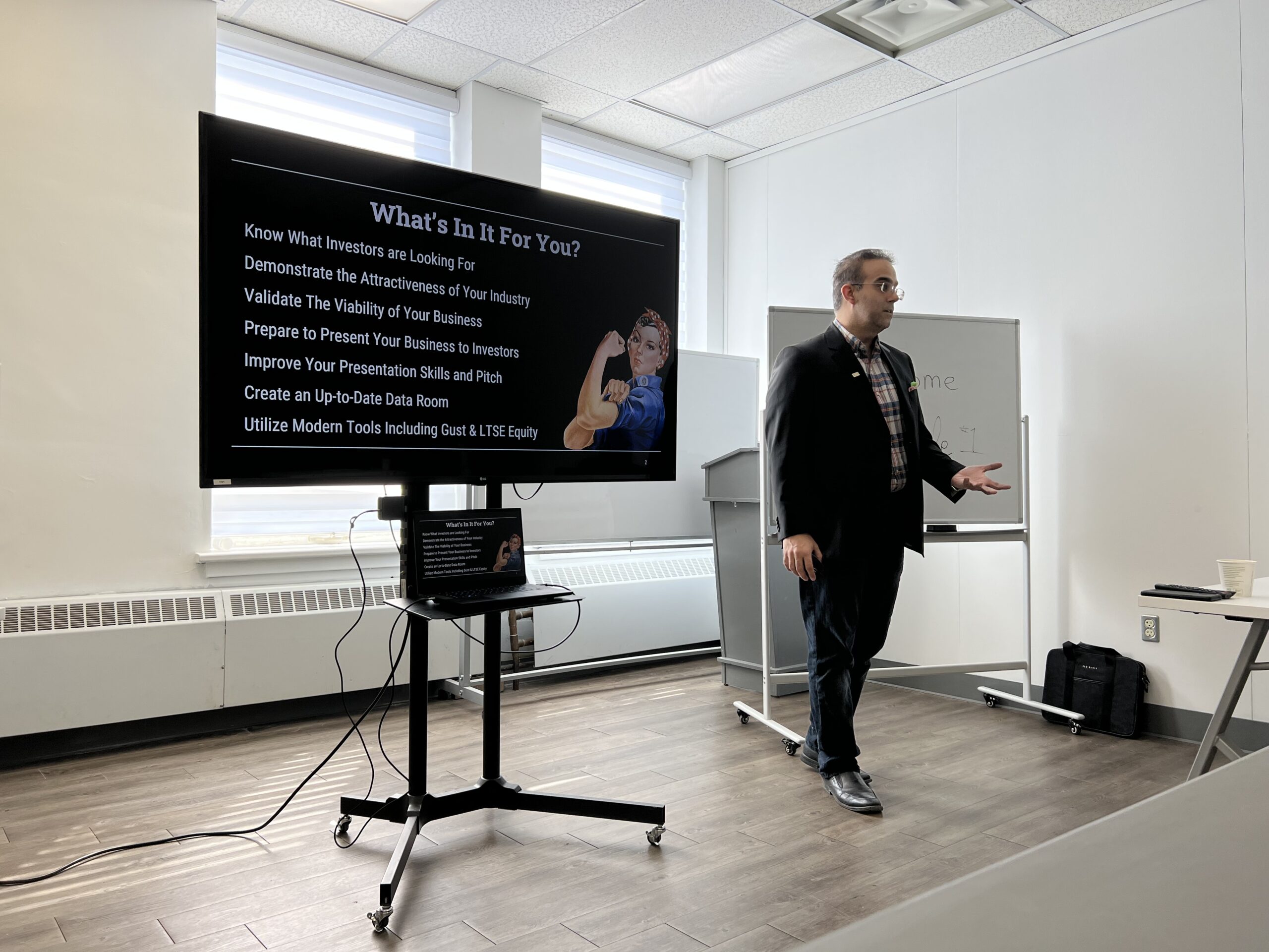 Entrepreneurial Coach lecturing beside a TV at the Niagara Falls Innovation Hub