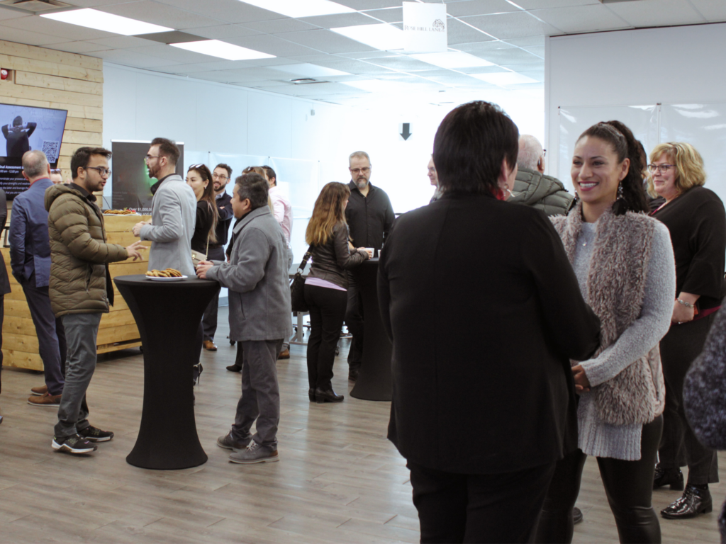 A large group of people networking at the Niagara Falls Innovation Hub