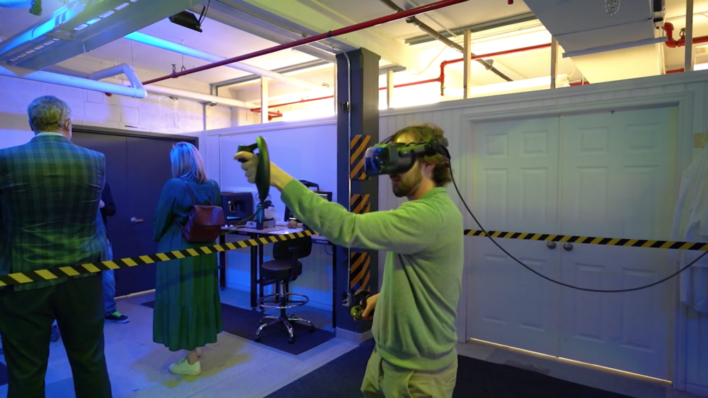 Man using a VR headset and joysticks in a Makerspace